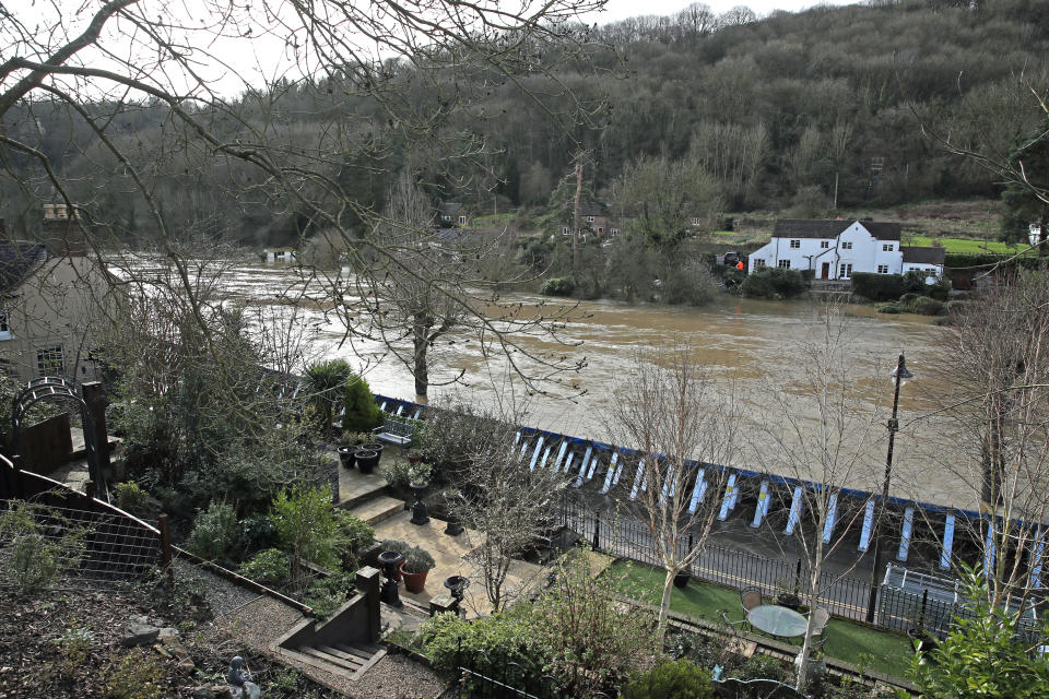 Temporary flood barriers on the Wharfage in Ironbridge, Shropshire, as the River Severn remains high, with warnings of further flooding across the UK. See PA story WEATHER Storm. Photo credit should read: Nick Potts/PA Wire