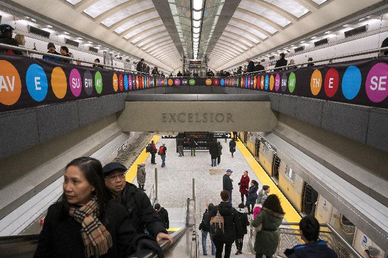 People walk about the newly opened Second Ave. Subway 86th Street station in New York Sunday, Jan. 1, 2017. The opening of three new stations on the newly opened Second Ave. subway marks a decades long plan to bring rail transportation to Manhattan's Upper East Side. (AP Photo/Craig Ruttle)