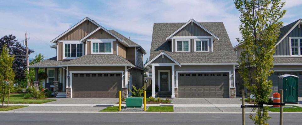 Brand new residential houses with concrete driveway and asphalt road in front