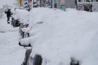 FILE PHOTO: A driver shovels out his car following a winter snow storm in Somerville