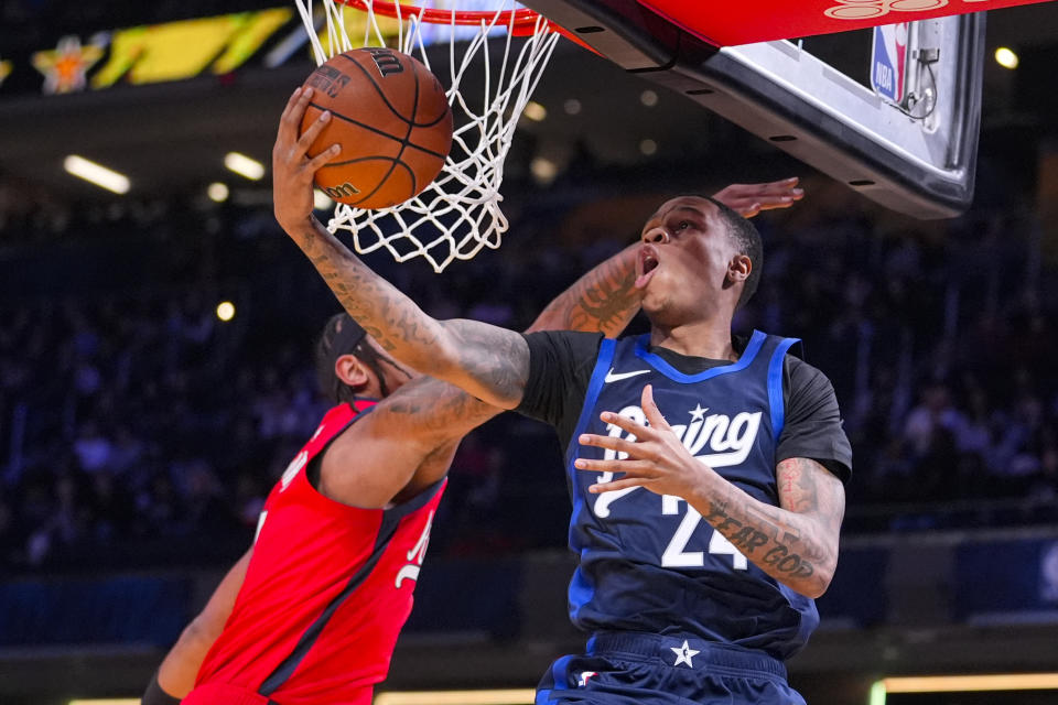 Jordan Hawkins, right, of the New Orleans Pelicans shoots in front of Paolo Banchero of the Orlando Magic during an NBA Rising Stars basketball game in Indianapolis, Friday, Feb. 16, 2024. (AP Photo/Michael Conroy)