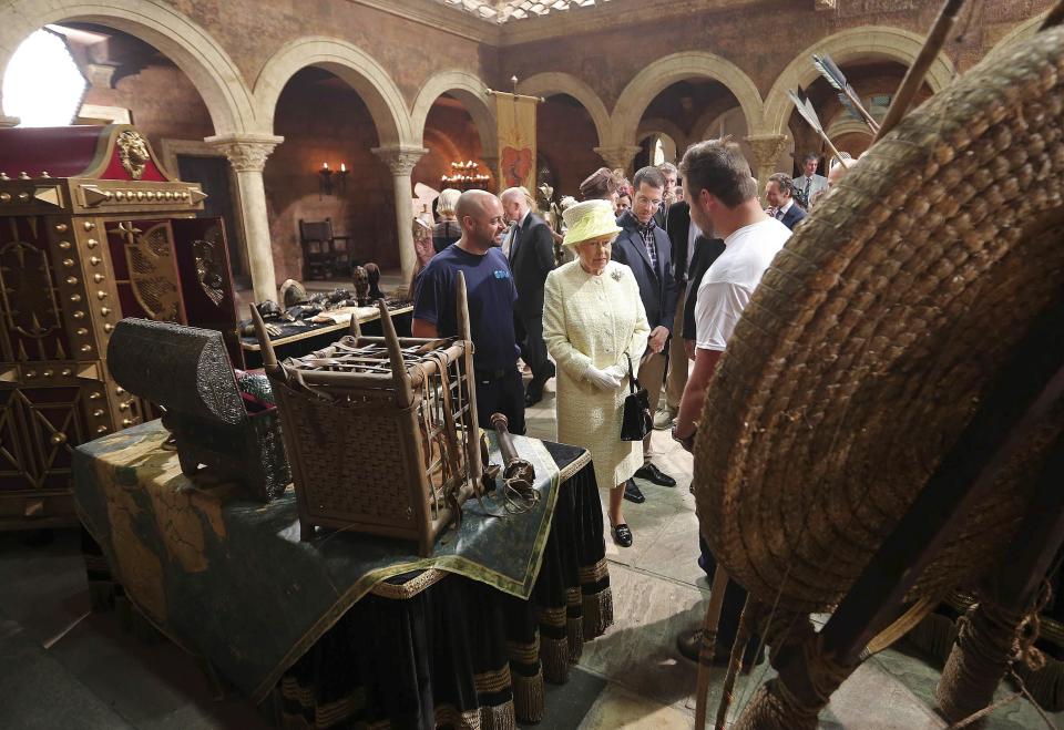 Britain's Queen Elizabeth looks at props as she visits the set of TV series Game of Thrones, in Belfast