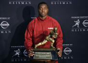 Alabama receiver Amari Cooper, a Heisman Trophy finalist, poses with the trophy at a press conference, Friday, Dec. 12, 2014, in New York. The award is to be presented Saturday. (AP Photo/Richard Drew)