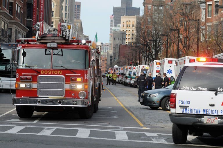 A long line of ambulances wait in a staging area after explosions rocked the finish area of the Boston Marathon on April 15, 2013