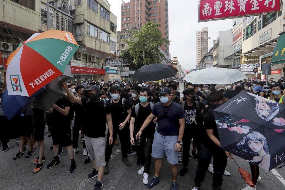 Protesters march in Hong Kong Saturday, July 13, 2019. Several thousand people marched in Hong Kong on Saturday against traders from mainland China in what is fast becoming a summer of unrest in the semi-autonomous Chinese territory. (AP Photo/Kin Cheung)