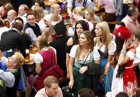 Young women wearing traditional Bavarian dirndls arrive at a beer tent during Munich's 180th Oktoberfest October 3, 2013. REUTERS/Michaela Rehle