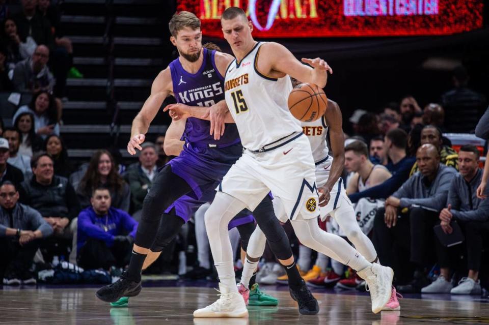 Sacramento Kings forward Domantas Sabonis (10) defends Denver Nuggets center Nikola Jokic (15) during an NBA game on Friday, Feb. 9, 2024 at Golden 1 Center. 