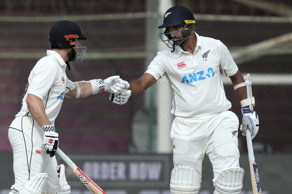 New Zealand's Kane Williamson, left, celebrates with Ish Sodhi after hitting a boundary during the fourth day of first test cricket match between Pakistan and New Zealand, in Karachi, Pakistan, Thursday, Dec. 29, 2022. (AP Photo/Fareed Khan)