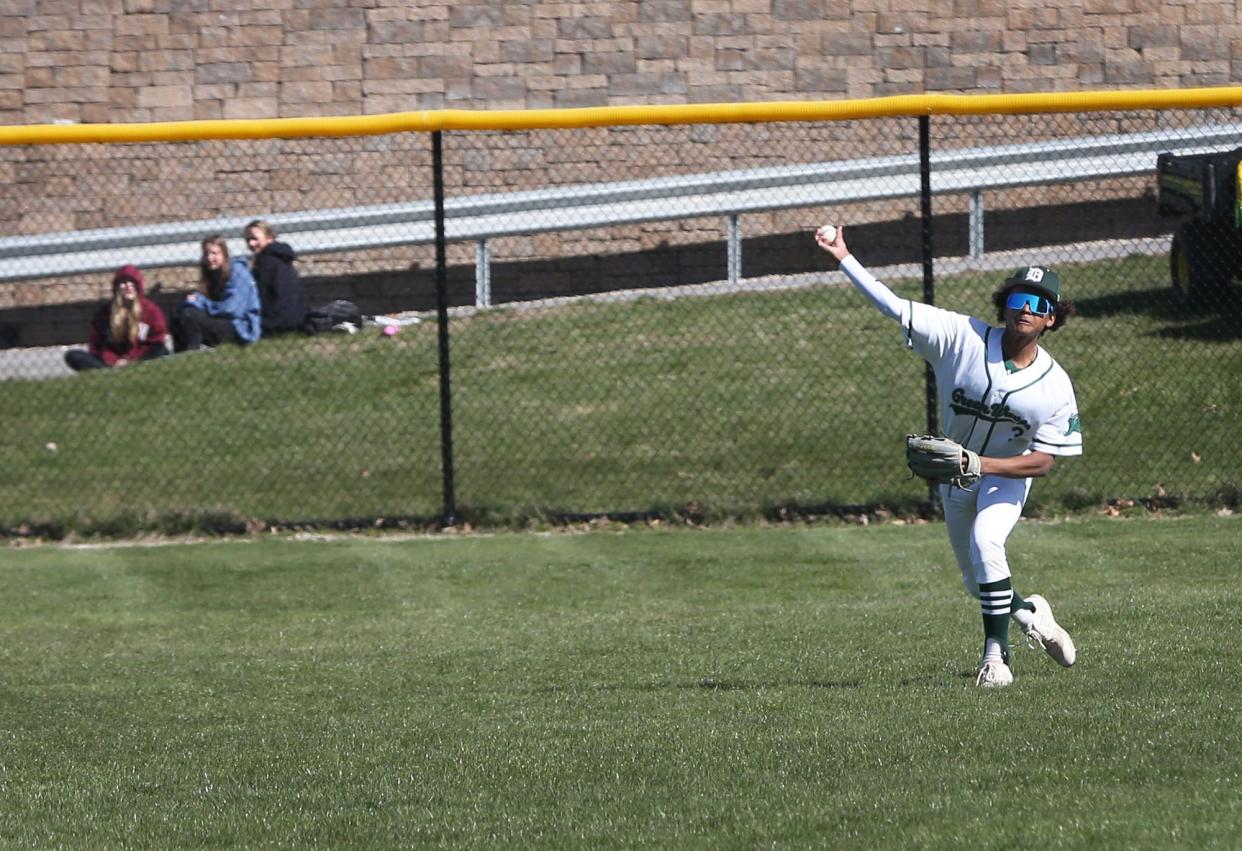 Dover freshman center fielder Amari Lewis makes a catch for an out and gets the ball to first for a double play in the first inning of Friday's Division I game against Winnacunnet.
