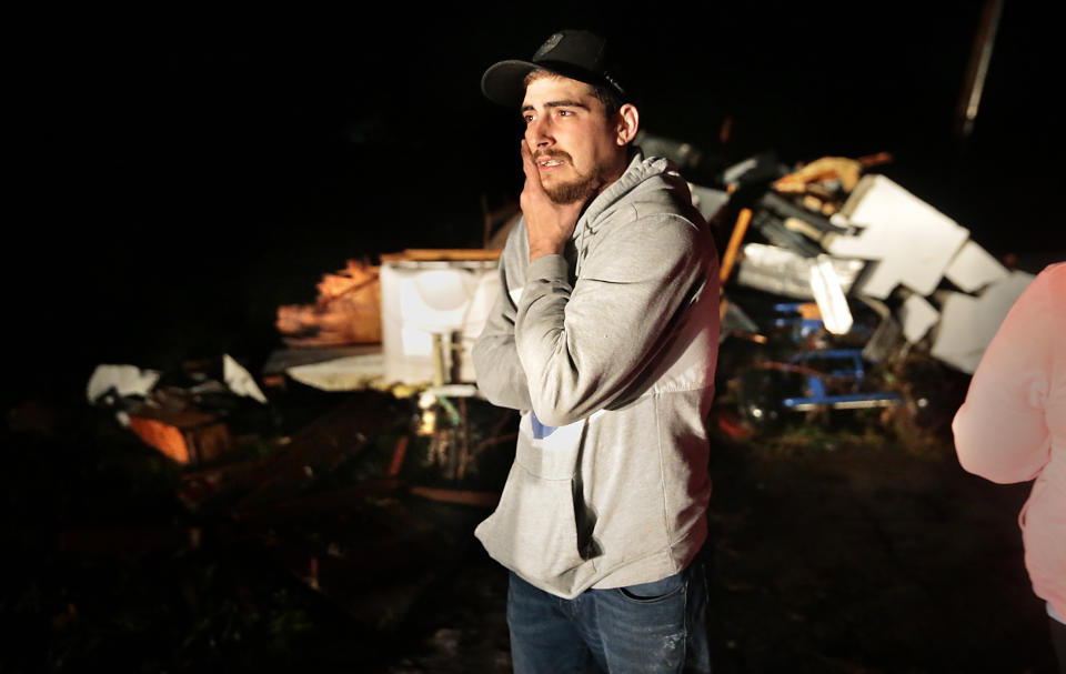 Joe Newland stands among the remains of his camper that was destroyed along with his rental house in Fredericktown, Mo. Monday, Oct. 25, 2021 after a tornado left his family homeless Sunday night. Newland, his fiance and three children went into their basement as the storm approached but were blocked by a freezer as they went to leave it. Eventually they crawled through a hole to escape the house. (Robert Cohen/St. Louis Post-Dispatch via AP)