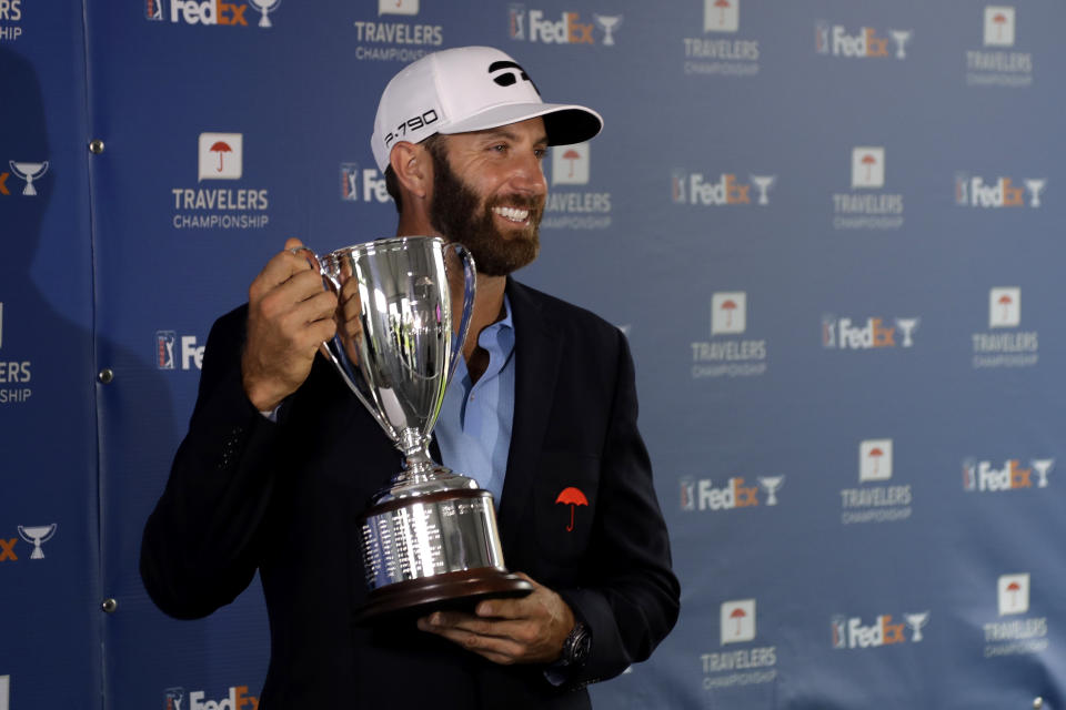 Dustin Johnson poses with the trophy after winning the Travelers Championship golf tournament at TPC River Highlands, Sunday, June 28, 2020, in Cromwell, Conn. (AP Photo/Frank Franklin II)