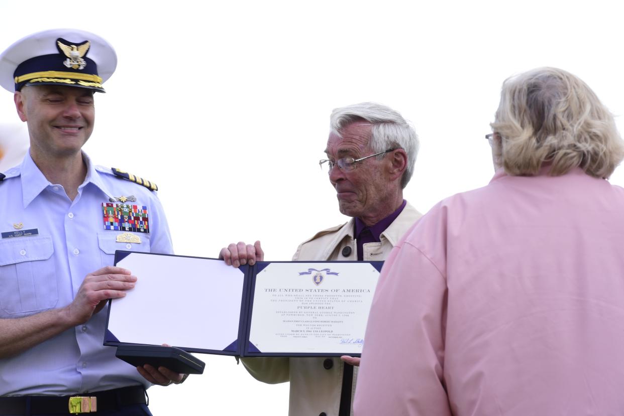 U.S. Coast Guard Capt. Brad Kelly, commander of Sector Detroit, posthumously presents the Purple Heart Medal to Ric Marion, the nephew of Glyone Mahaffy a former USS Leopold crew member, during a ceremony at Fort Gratiot Lighthouse in Fort Gratiot, on Monday, May 23, 2022.