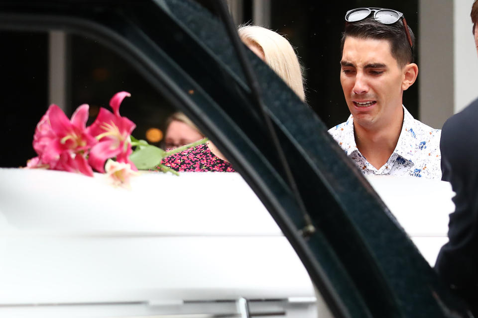 Nathaniel Clarke, brother to Hannah Clarke, looks on as the coffin is placed in the hearse, during the funeral for Hannah Clarke and her three children Aaliyah, Laianah and Trey in Brisbane.