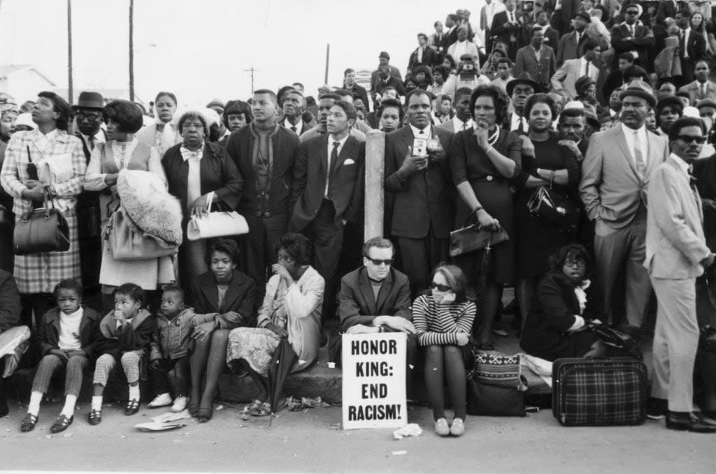 9th April 1968: Mourners waiting for Dr Martin Luther King’s funeral cortege to pass them outside Moorhouse College in Atlanta, Georgia. (Photo by Keystone/Getty Images)