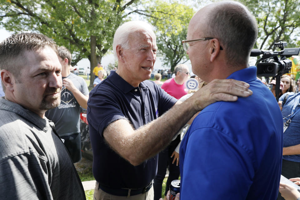 Democratic presidential candidate former Vice President Joe Biden talks with Chris Rolwes, of Cedar Rapids, Iowa, right, during the Hawkeye Area Labor Council Labor Day Picnic, Monday, Sept. 2, 2019, in Cedar Rapids, Iowa. (AP Photo/Charlie Neibergall)