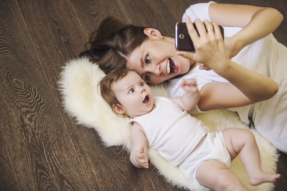 Mom with toddler looking at cellphone