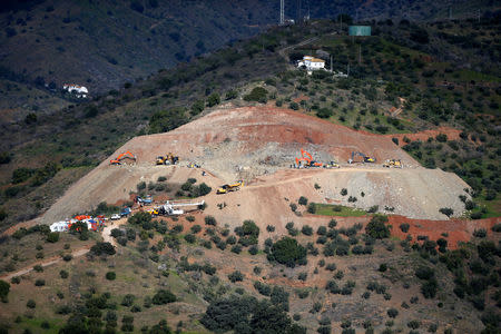 An idle drill (bottom) is seen next to diggers and trucks removing sand at the area where Julen, a Spanish two-year-old boy fell into a deep well six days ago when the family was taking a stroll through a private estate, in Totalan, southern Spain, January 19, 2019. REUTERS/Jon Nazca