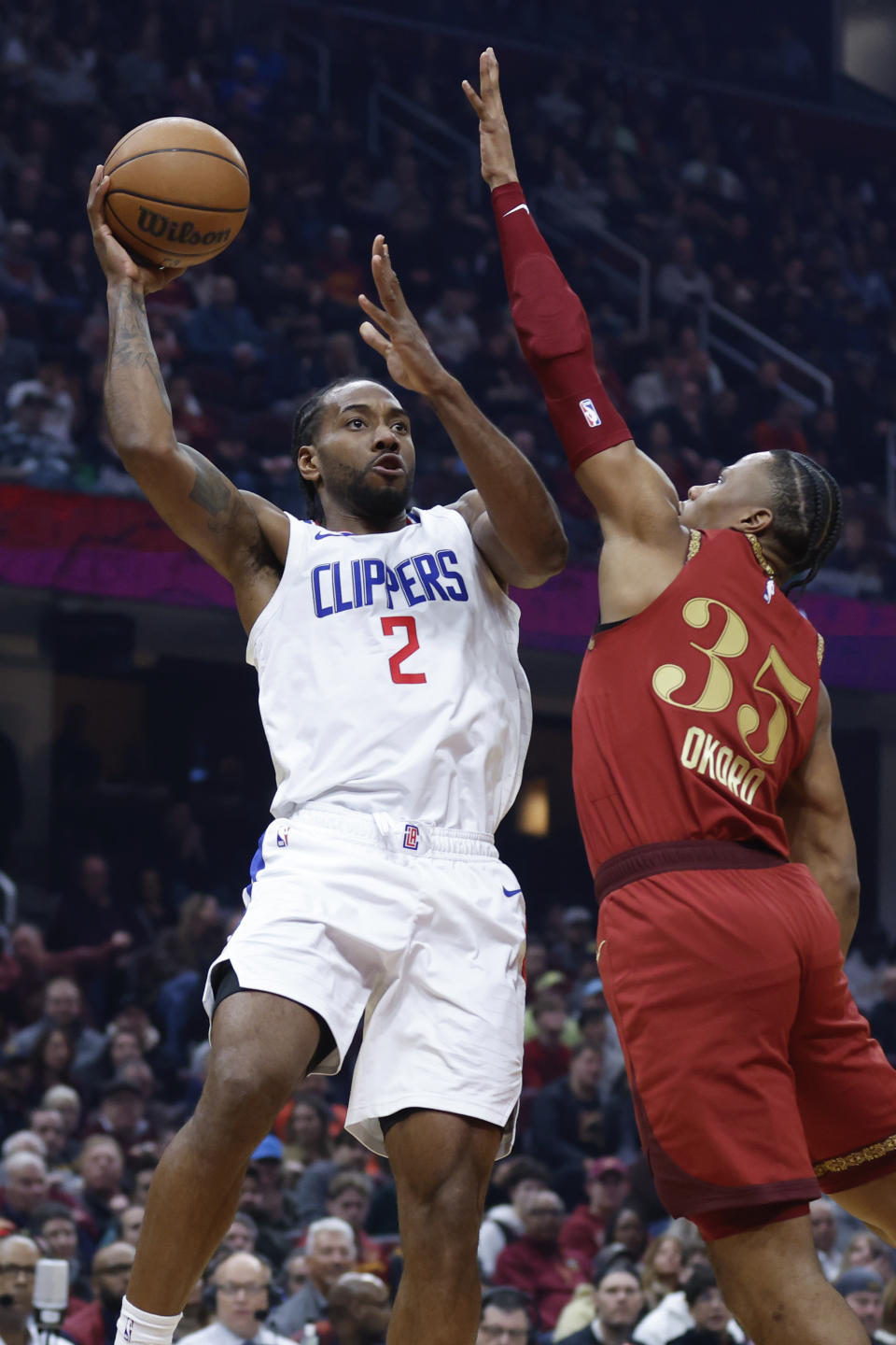 Los Angeles Clippers forward Kawhi Leonard (2) shoots against Cleveland Cavaliers forward Isaac Okoro (35) during the first half of an NBA basketball game, Monday, Jan. 29, 2024, in Cleveland. (AP Photo/Ron Schwane)