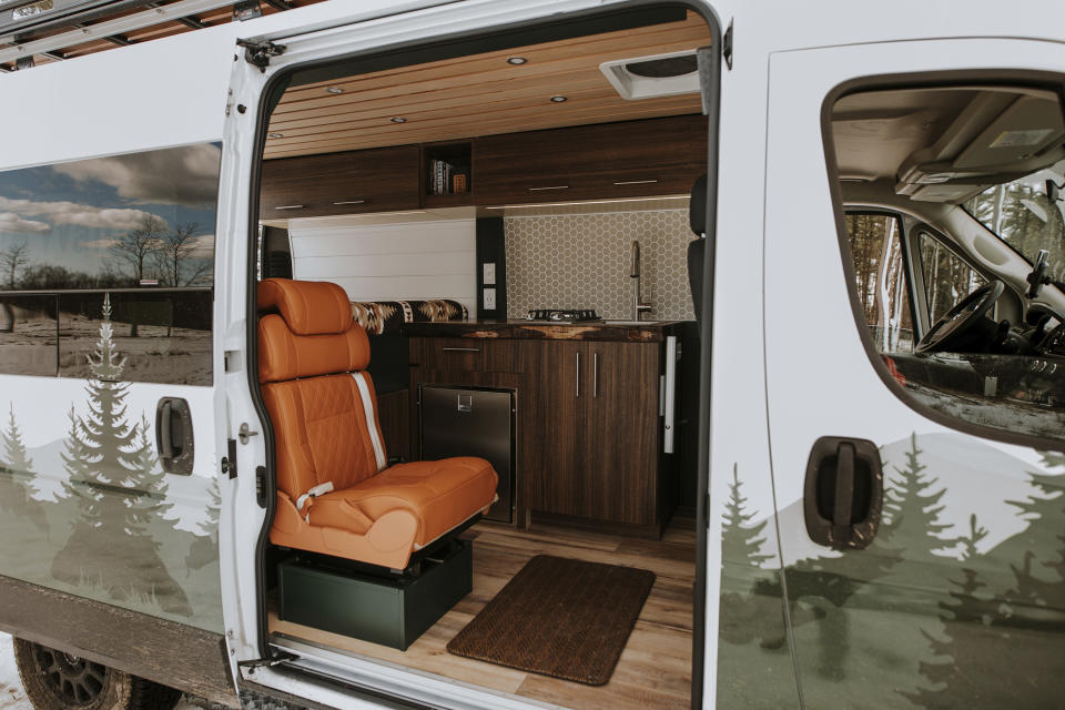 This image provided by Walden Campervans shows a customized van from Walden Campervans. Whether in vans, campers or school buses, the pandemic grew a new crop of people who took off on wheels after tricking out their rides. (Sarah Jayne Photo Co./Walden Campervans via AP).