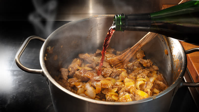 wine pouring into stew pan