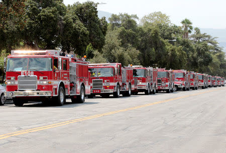 Fire trucks wait to depart into the hillsides during La Tuna Canyon fire over Burbank, California, September 3, 2017. REUTERS/ Kyle Grillot