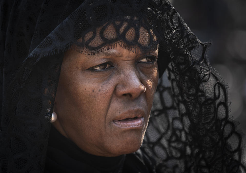 Widow Grace Mugabe wears a black veil as she follows the casket of former president Robert Mugabe to an air force helicopter for transport to a stadium where it will lie in state, at his official residence in the capital Harare, Zimbabwe Thursday, Sept. 12, 2019. Controversy over where and when Robert Mugabe will be buried has overshadowed arrangements for Zimbabweans to pay their respects to the deceased leader. (AP Photo/Ben Curtis)