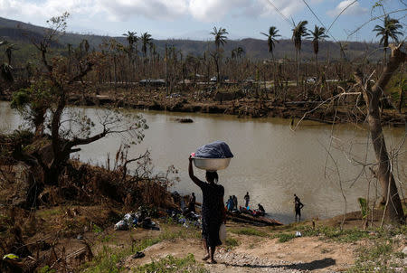 Women do their laundry at the shores of a river after Hurricane Matthew hit Jeremie, Haiti. REUTERS/Carlos Garcia Rawlins