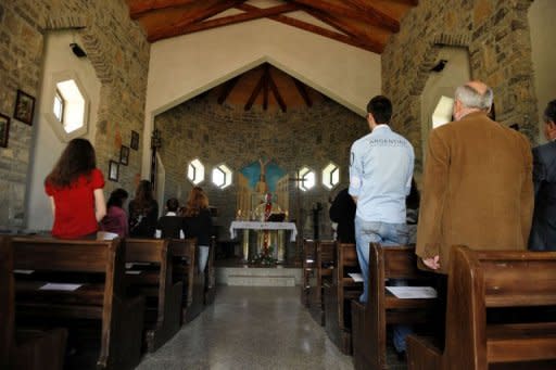 Villagers pray at a Catholic church in the village of Kravaseri in May 2012. Only about 50,000 of Kosovo's 1.7 million citizens are Catholics, while more than 90 percent of the population are Muslim