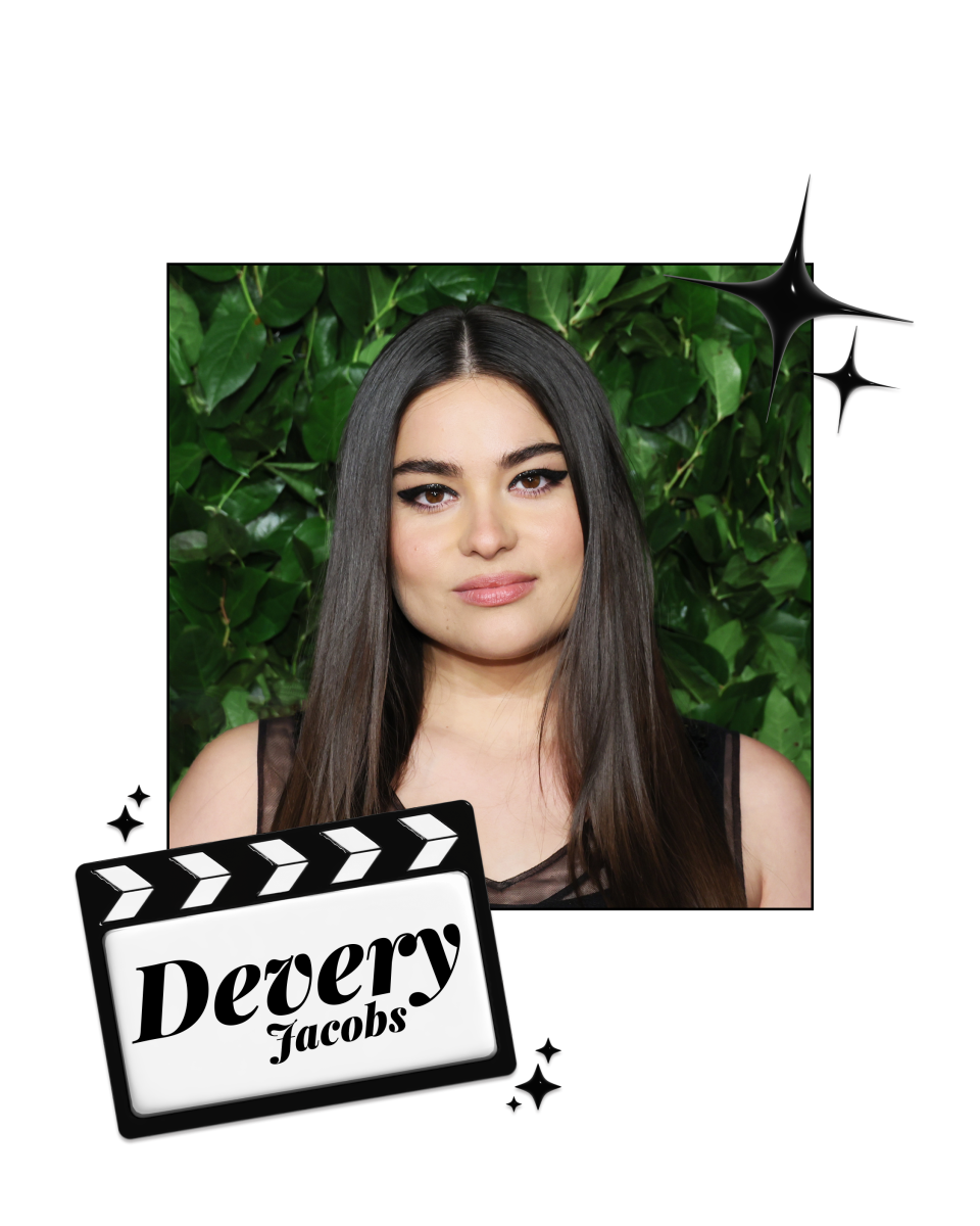 Devery Jacobs in front of a green wall