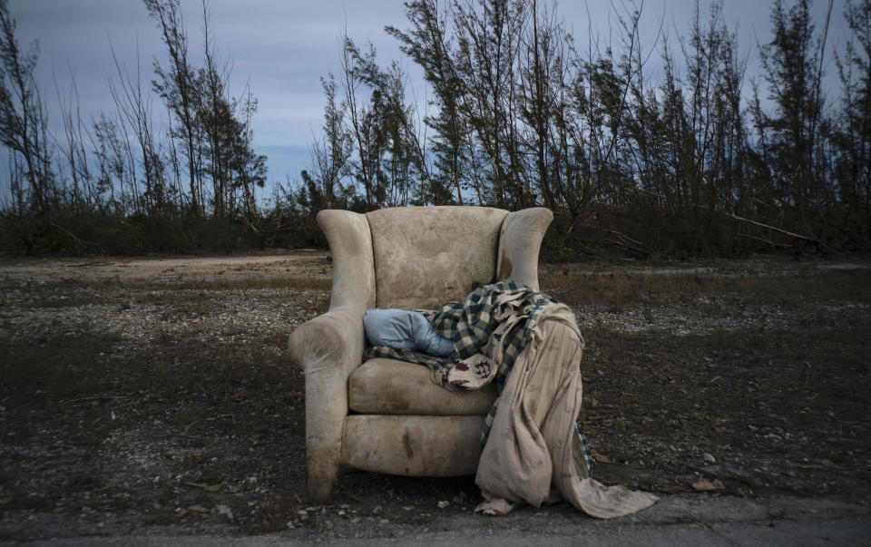 The lounger in which Virginia Mosvold was rescued from her home in Ol' Freetown Farm, flooded by rains brought on by Hurricane Dorian, lays abandoned on the side of a road on the outskirts of Freeport, Bahamas, Wednesday, Sept. 4, 2019. The 84-year-old Mosvold was taken to a hospital in Freeport. Rescue crews in the Bahamas fanned out across a blasted landscape of smashed and flooded homes trying to reach drenched and victims of Dorian. (AP Photo/Ramon Espinosa)