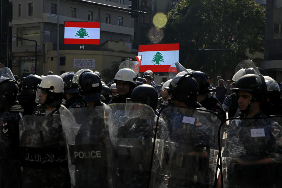 Riot police stand guard after they open a road in Beirut, Lebanon, Thursday, Oct. 31, 2019. Army units and riot police took down barriers and tents set up in the middle of highways and major intersections Thursday. (AP Photo/Bilal Hussein)