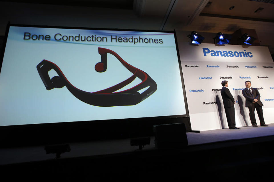 Panasonic's Shiro Kitajima, far right, and Vic Carlson, introduces the bone construction headphones during a news conference at the International Consumer Electronics Show. The headphones connect to a TV via the Bluetooth wireless standard and attach to your head like a normal set of headphones. But instead of using your ears, the headphones work like hearing aids by transmitting sound waves through your skull.