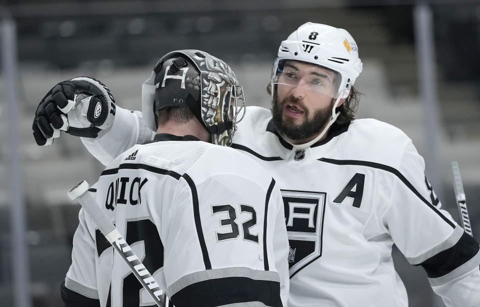 Los Angeles Kings defenseman Drew Doughty (8) hugs goaltender Jonathan Quick (32) after the team's 4-2 victory over the San Jose Sharks in an NHL hockey game Saturday, April 10, 2021, in San Jose, Calif. (AP Photo/Tony Avelar)