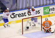 Montreal Canadiens center Jake Evans (71) and Alex Belzile (60) celebrate teammate Montreal Canadiens right wing Joel Armia, not shown, scoring on Philadelphia Flyers goaltender Carter Hart (79) during the second period of an NHL Eastern Conference Stanley Cup hockey playoff game in Toronto, Friday, Aug. 14, 2020. (Frank Gunn/The Canadian Press via AP)