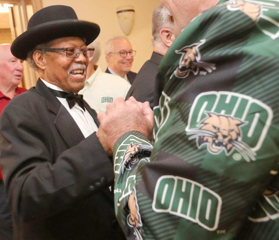 Summit County Sports Hall of Fame inductee Andy Daniels is greeted by his Ohio Bobcats friends before the banquet Tuesday at Annunciation Greek Orthodox Church in Akron.