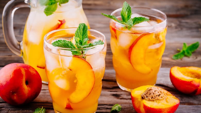 peach sangria in glasses with pitcher 