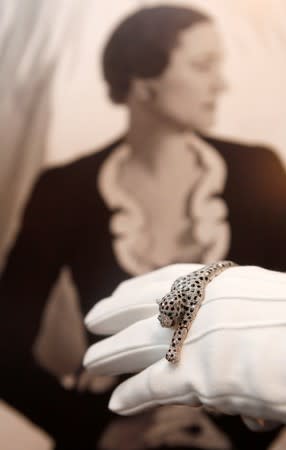 FILE PHOTO: An employee from Sotheby's jewellery department, holds an onyx and diamond panther bracelet by Cartier in London