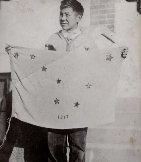 Benny holding his winning flag design