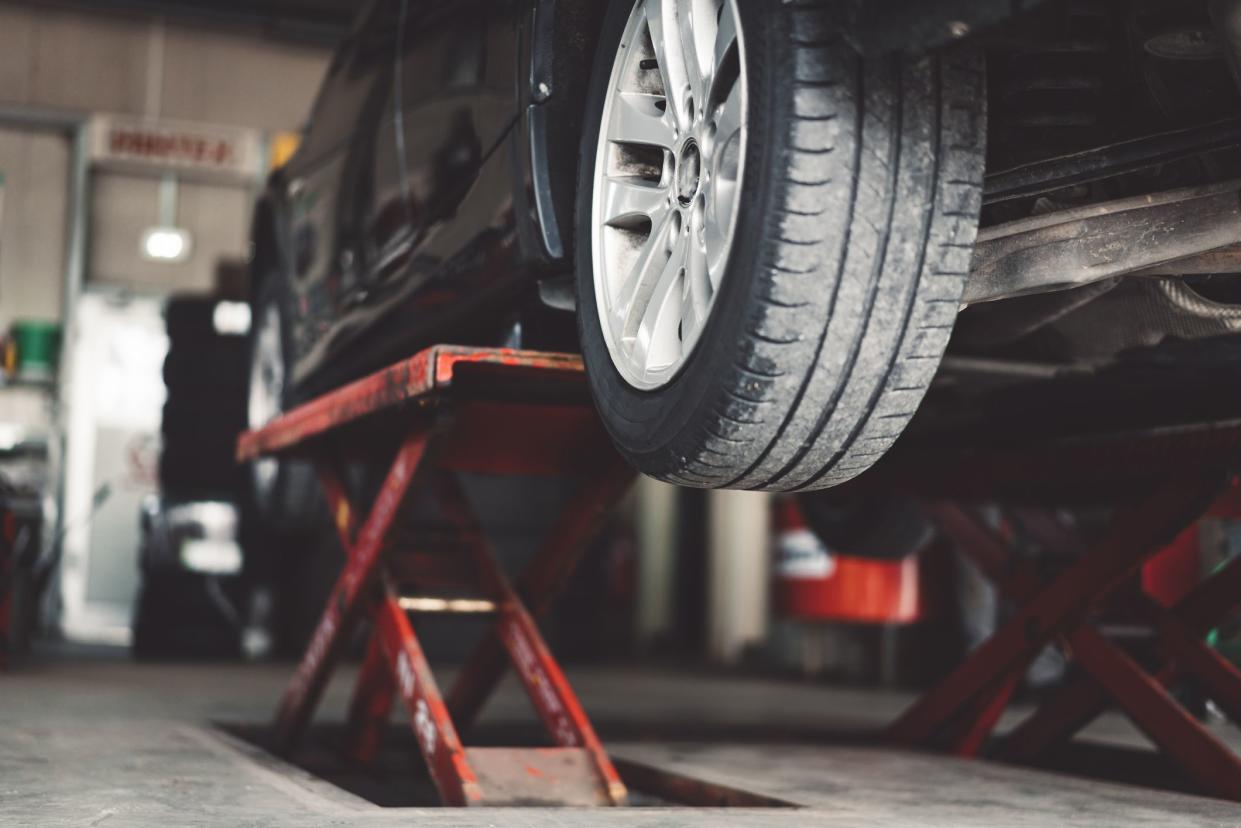 car in lift at oil change place