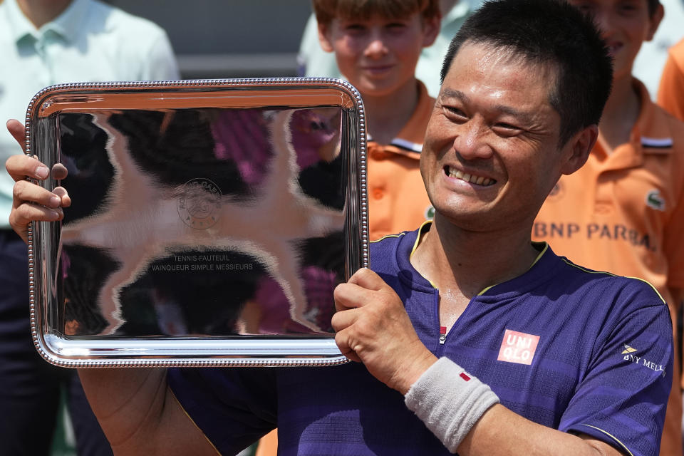 FILE - Japan's Shingo Kunieda holds the trophy after winning the men's wheelchair singles final match against Argentina's Gustavo Fernandez in three sets, 6-2, 5-7, 7-5, at the French Open tennis tournament in Roland Garros stadium in Paris, France, on June 4, 2022. Kunieda, the most successful player in the history of wheelchair tennis, announced his retirement from the sport on Sunday, Jan. 22, 2023, at the age of 38. (AP Photo/Michel Euler, File)