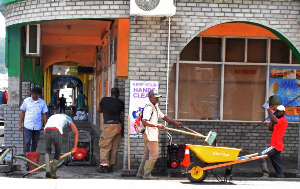 Workers clear drains ahead of the arrival of Hurricane Beryl in Kingstown, St. Vincent and the Grenadines Sunday.