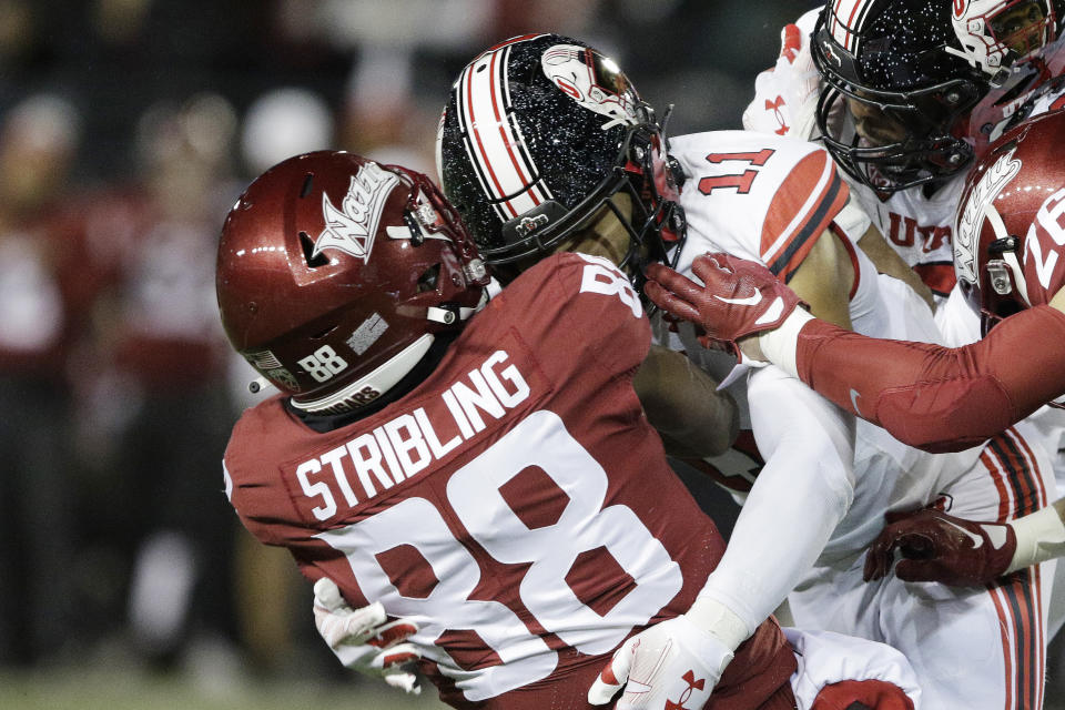 Utah safety R.J. Hubert (11) tackles Washington State wide receiver De'Zhaun Stribling (88) during the first half of an NCAA college football game, Thursday, Oct. 27, 2022, in Pullman, Wash. (AP Photo/Young Kwak)