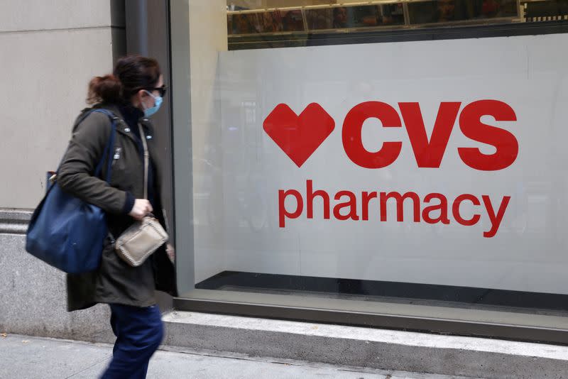 FILE PHOTO: A person walks by a CVS pharmacy store in Manhattan, New York