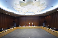 Japanese Foreign Ministry's Director-General of the Asian and Oceanian Affairs Bureau Takehiro Funakoshi, center, U.S. Special Representative for North Korea, Sung Kim, second from left in background, and South Korea's Special Representative for Korean Peninsula Peace and Security Affairs Noh Kyu-duk, right in background, attend their trilateral meeting on North Korea at Foreign Ministry Tuesday, Sept. 14, 2021 n Tokyo. (AP Photo/Eugene Hoshiko)