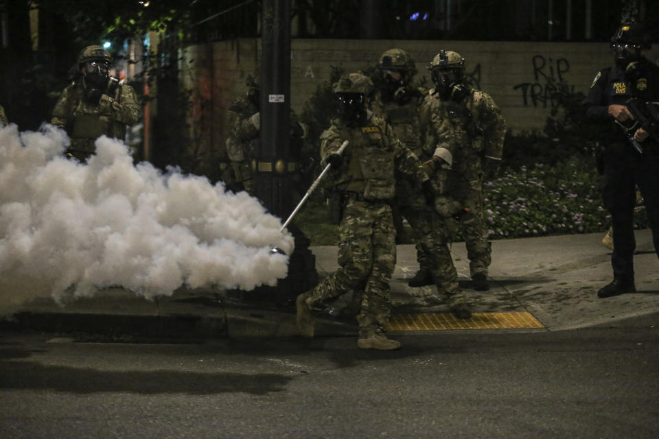 Police respond to protesters during a demonstration, Friday, July 17, 2020 in Portland, Ore. Militarized federal agents deployed by the president to Portland, fired tear gas against protesters again overnight as the city’s mayor demanded that the agents be removed and as the state’s attorney general vowed to seek a restraining order against them.(Dave Killen/The Oregonian via AP)