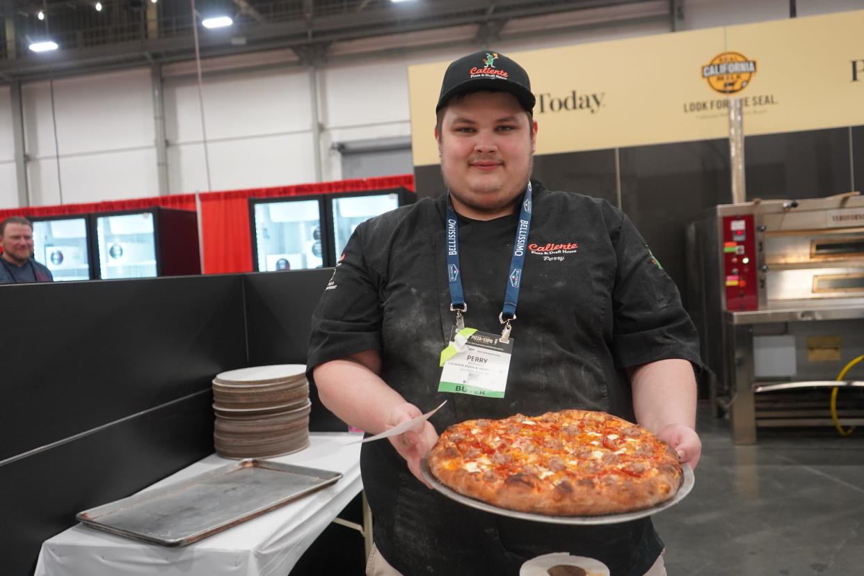 Perry Bogacz, of Caliente Pizza & Draft House, with one of his award-winning pizzas.