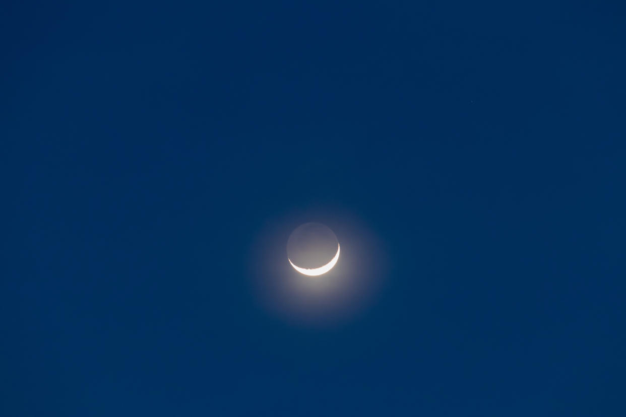 Earthshine is a soft, faint glow on the dark side of the moon. Earthshine occurs when sunlight reflects off the Earth's surface and illuminates the unlit portion of the Moon's surface.