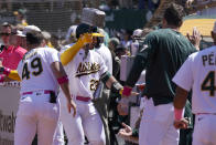 Oakland Athletics' Shea Langeliers (23) is congratulated by teammates after hitting a two-run home run during the seventh inning of a baseball game against the Texas Rangers in Oakland, Calif., Sunday, May 14, 2023. (AP Photo/Jeff Chiu)