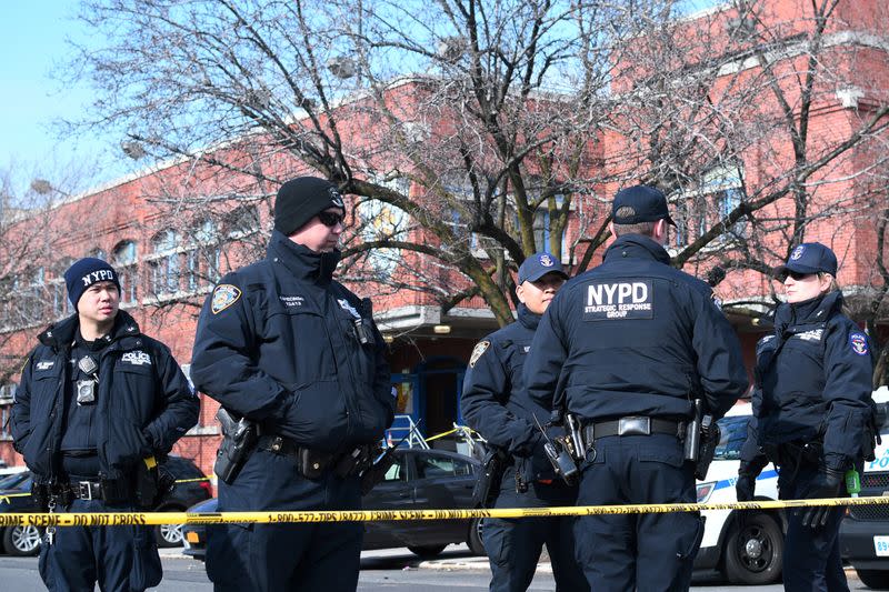 FILE PHOTO: New York Police Department officers gather outside of the 41st Precinct in the Bronx borough of New York after a shooting there in New York City