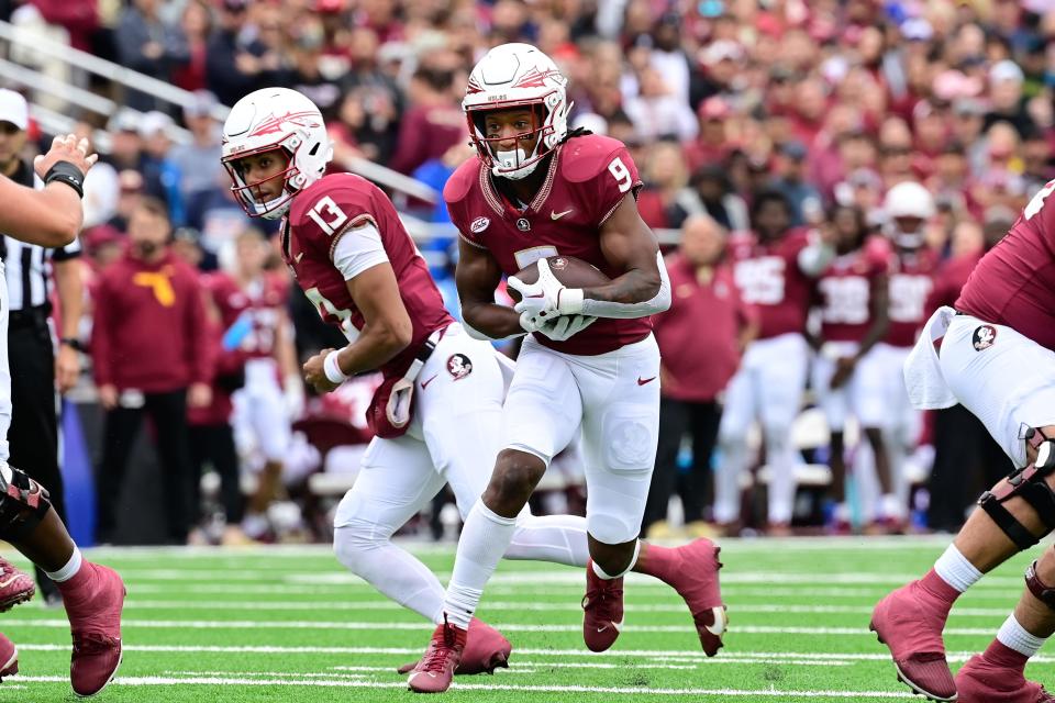 Sep 16, 2023; Chestnut Hill, Massachusetts, USA; Florida State Seminoles running back Lawrance Toafili (9) runs the ball after a hand-off from quarterback Jordan Travis (13) during the first half at Alumni Stadium. Mandatory Credit: Eric Canha-USA TODAY Sports